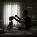 Father Styling Daughter's Hair in Ballet Dress by Window Light