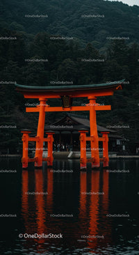 Iconic Orange Torii Gate Before Lush Mountain Scenery