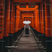 Man Walking Through Vibrant Orange Torii Gates in Kyoto