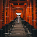 Man Walking Through Vibrant Orange Torii Gates in Kyoto
