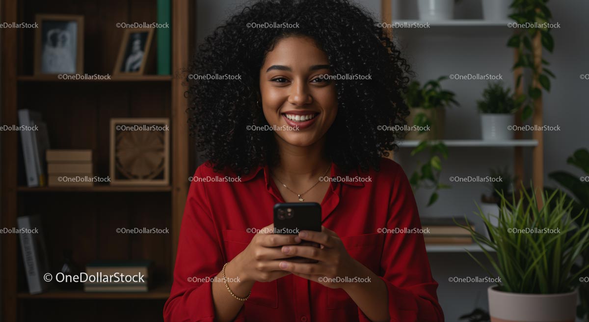 Woman with Curly Hair Smiling While Holding Smartphone