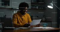 Smiling Man Reading Documents in Cozy Home Office