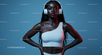 Confident Woman in White Top Wearing Headphones on Blue Background