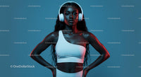 Confident Woman in Headphones Posing Against Blue Background