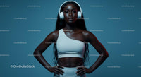 Confident Athletic Woman in Studio with Headphones