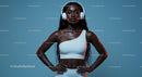 Confident Woman with Headphones in Stylish White Outfit