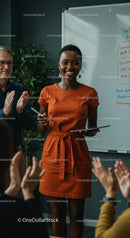 Confident Woman Giving Engaging Presentation in Orange Dress