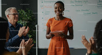 Confident Woman Giving Engaging Presentation in Orange Dress