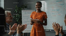 Confident Woman Giving Engaging Presentation in Orange Dress