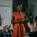 Confident Woman Giving Engaging Presentation in Orange Dress