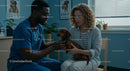 Veterinarian Examining Dachshund with Concerned Owner
