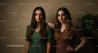 Elegant Women in Green and Brown Polka Dot Dresses