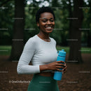 Smiling Woman with Water Bottle in Lush Green Park