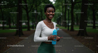Smiling Woman Enjoying Exercise in a Green Park Setting