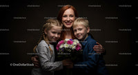 Smiling Mother with Children Holding Colorful Bouquet