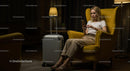 Woman Relaxing with Smartphone in Cozy Armchair