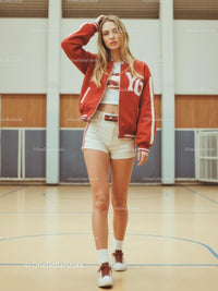 Trendy Woman in Red Varsity Jacket on Indoor Court