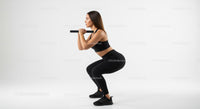 Woman in Squat Position with Weights on White Background