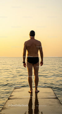 Man Contemplating Ocean at Sunset on a Pier