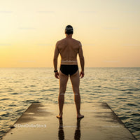 Silhouette of Swimmer at Sunset on Ocean Dock