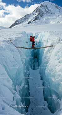 Adventurer Crossing Ice Bridge Over Crevasse in Snowy Mountains