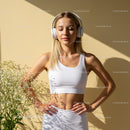 Woman in White Crop Top Relaxing in Sunlight with Headphones