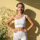 Woman Relaxing in Fitness Wear with Headphones in Sunlight
