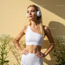 Confident Woman in White Activewear with Headphones