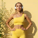 Confident Woman in Yellow Workout Gear with Headphones