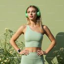 Woman in Green Activewear with Headphones in Sunshine