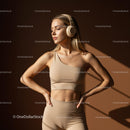 Modern Woman in Beige Fitness Apparel with Headphones