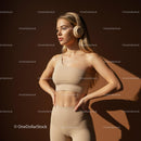 Confident Woman in Beige Activewear with Headphones