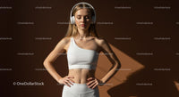 Focused Woman in White Sportswear with Headphones