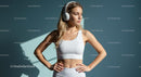 Confident Woman in White Activewear with Headphones