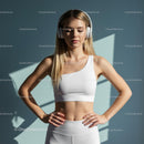 Fit Woman in White Sportswear Meditating with Headphones