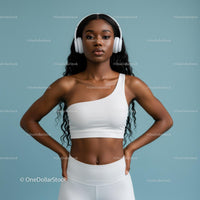 Confident Woman in White Workout Outfit with Headphones