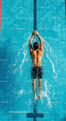 Male Swimmer Practicing Backstroke in Blue Pool
