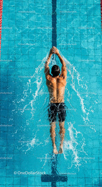 Male Swimmer Practicing Backstroke in Blue Pool