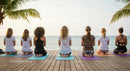 Women Practicing Yoga on Tropical Beach at Sunset