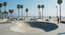 Skateboarder Enjoying Sunny Skatepark by the Beach