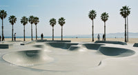 Skateboarder Enjoying Sunny Skatepark by the Beach