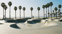 Skateboarder Enjoying Sunny Skatepark by the Beach