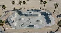Skateboarder Enjoying Sunny Skatepark by the Beach