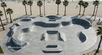 Skateboarder Enjoying Sunny Skatepark by the Beach