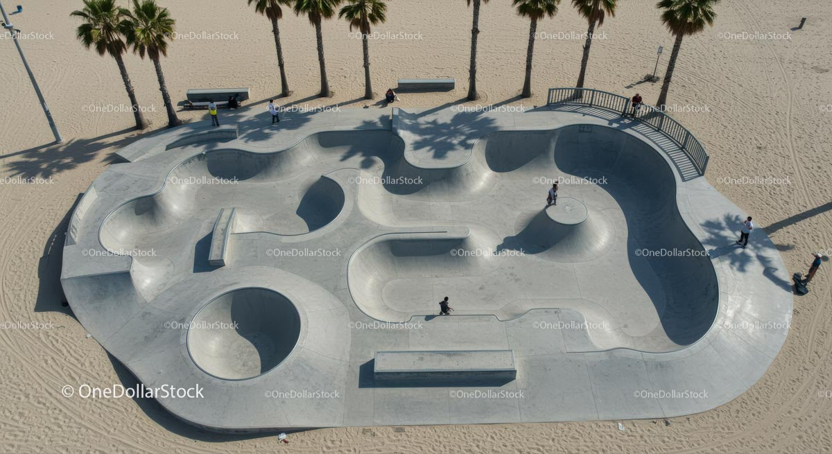 Skateboarder Enjoying Sunny Skatepark by the Beach