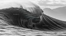 Surfer Riding Massive Ocean Wave in Scenic View