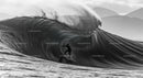 Surfer Tackling a Massive Ocean Wave with Skill