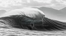 Silhouette of a Surfer Riding a Massive Ocean Wave