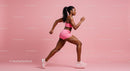 Athletic Woman Running in Pink Sportswear on Pink Background