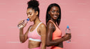 Active Women in Pink Sportswear Hydrating After Workout